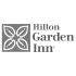Hilton Garden Inn logo featuring a square icon with four stylized leaves and serif typography.