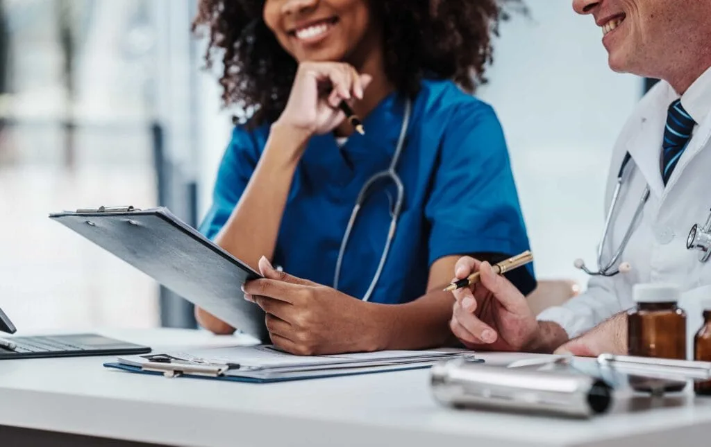 Diverse medical professionals collaboration during a patient consultation at a healthcare clinic in Los Angeles, CA.
