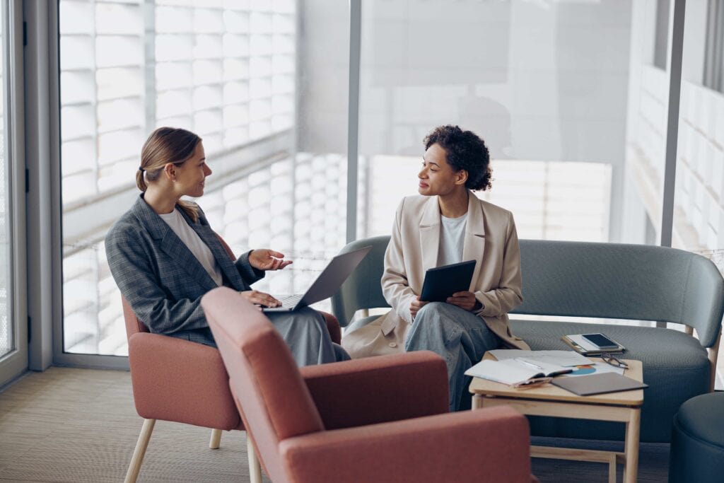 Two professionals engaged in business consulting services in a modern office setting in New York City, USA.