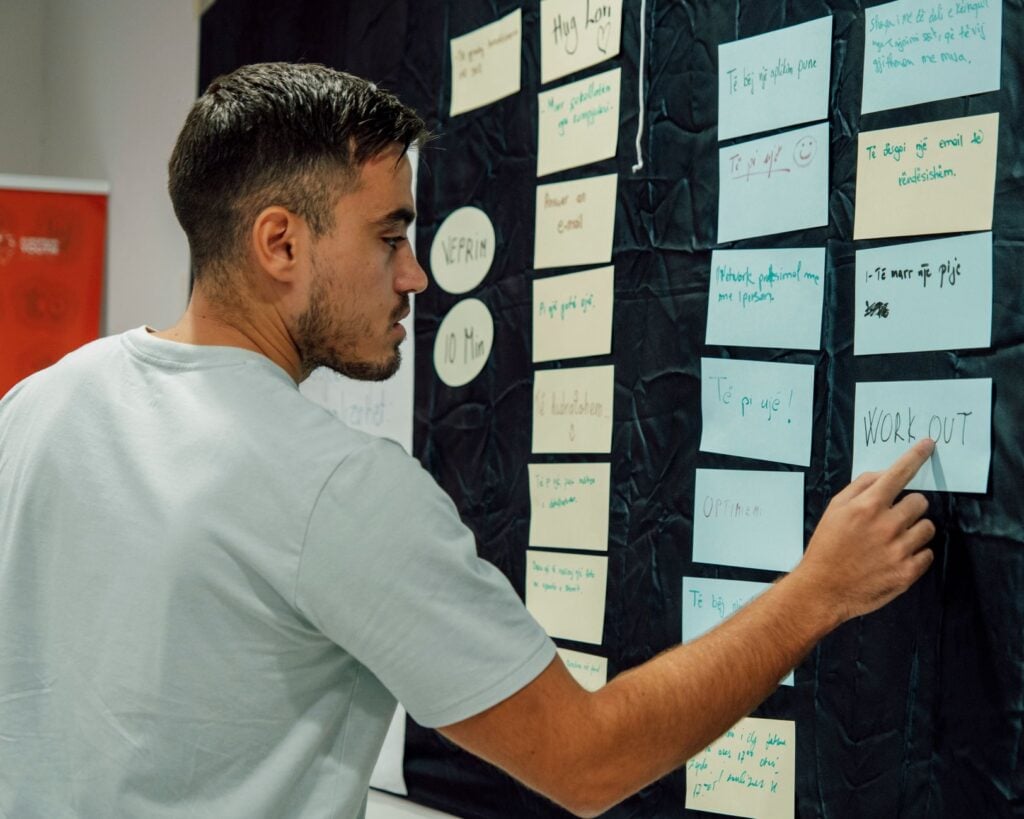 Building Better Hightop Hospitality Survey Questions for 2026 3 hospitality manager posting a survey action update on a staff bulletin board